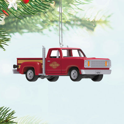 Miniature 1978 Dodge Li’l Red Express Christmas ornament in red and yellow with chrome stacks and turning wheels.
