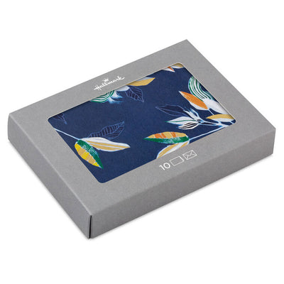 Elegant blank note cards with gold-accented tropical leaves on navy background, boxed set of 10 with white envelopes.
