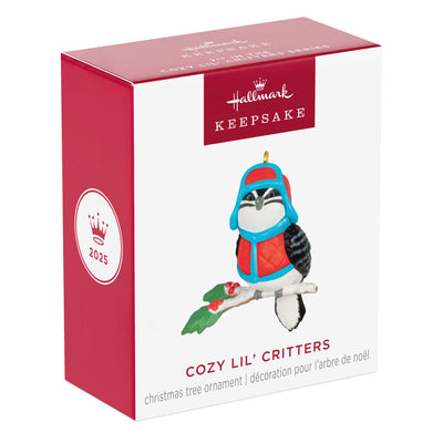 Miniature downy woodpecker ornament in red vest and trapper hat on snowy branch with holly berries, Hallmark Cozy Lil’ Critters
