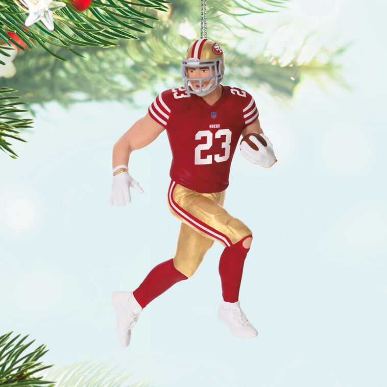 Christian McCaffrey ornament in 49ers red and gold uniform, number 23, action pose with football, Hallmark NFL Christmas collectible
