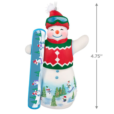 Hallmark Keepsake Ollie U. Halfpipe porcelain snowman ornament in red sweater vest, goggles, stocking hat, holding snowboard, snowy mountain scene