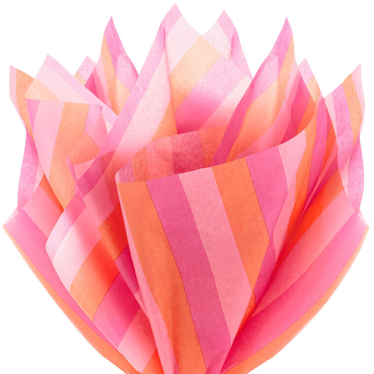 Hallmark tissue paper in horizontal magenta, orange, and pink stripes, styled in flat lay and fluffed in a gift bag for festive presentation
