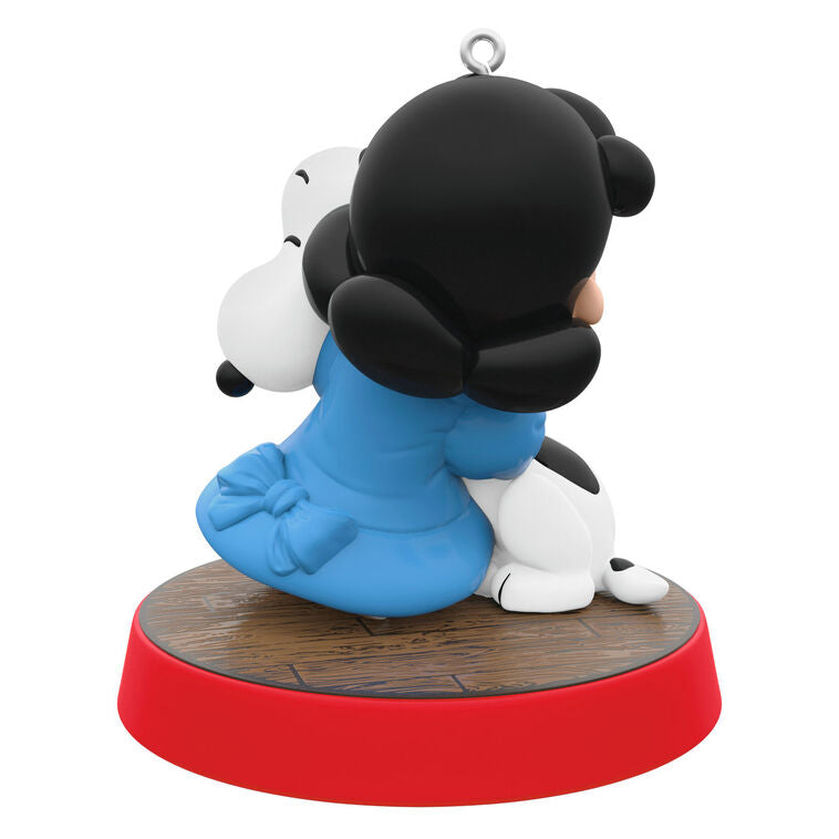 Hallmark Keepsake ornament of Lucy hugging Snoopy, Peanuts Gang Christmas Is series, red base with heartfelt sentiment