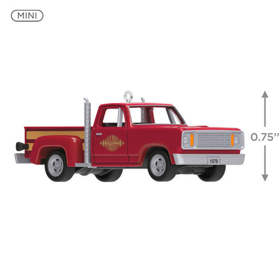 Miniature 1978 Dodge Li’l Red Express Christmas ornament in red and yellow with chrome stacks and turning wheels.