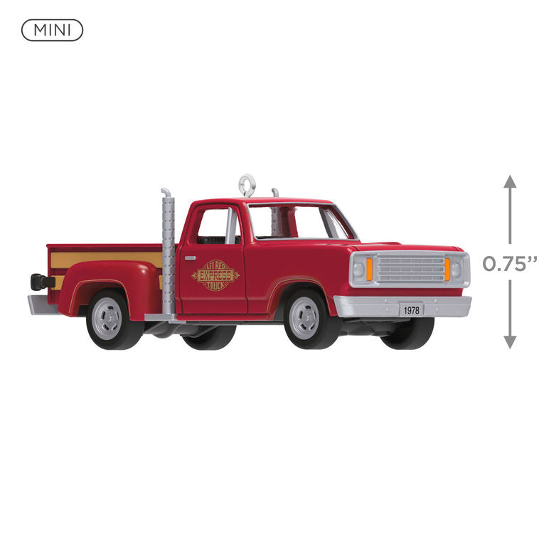 Miniature 1978 Dodge Li’l Red Express Christmas ornament in red and yellow with chrome stacks and turning wheels.