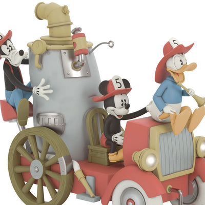 Mickey, Donald, and Goofy on a vintage fire engine ornament with light, sound, and motion from Mickey’s Fire Brigade.

