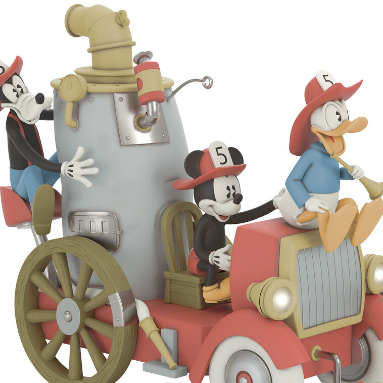 Mickey, Donald, and Goofy on a vintage fire engine ornament with light, sound, and motion from Mickey’s Fire Brigade.

