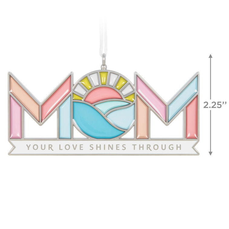 Stained-glass style metal ornament spelling “Mom” with sun and waves in the O, and banner reading “Your love shines through.”