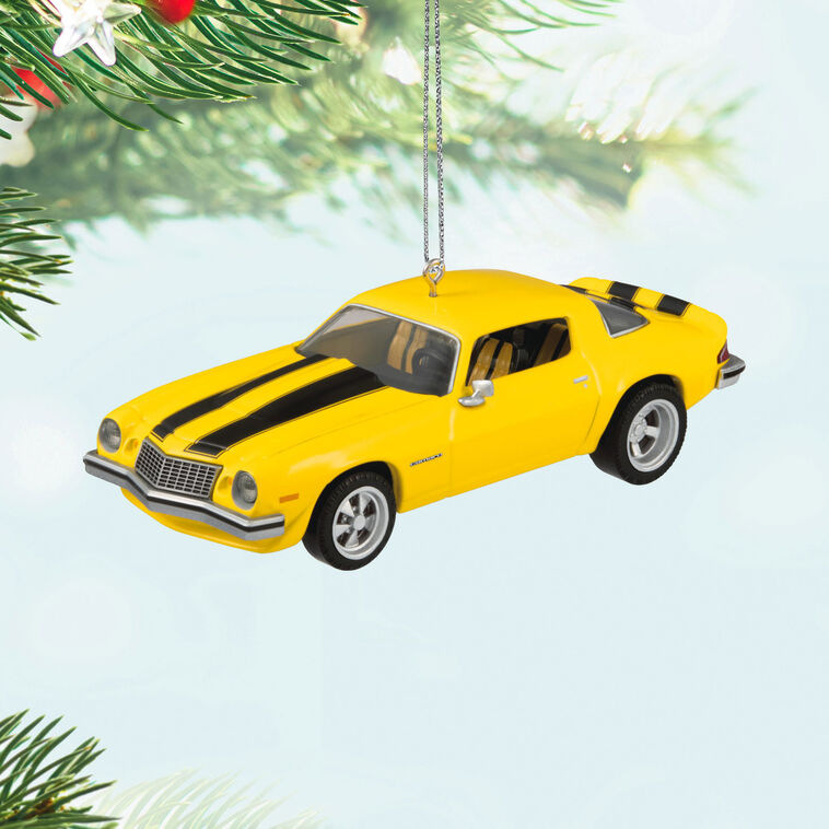 Yellow and black 1976 Chevrolet Camaro ornament from Transformers with turning wheels, representing Bumblebee in Earth vehicle disguise.