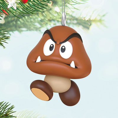 Hallmark Keepsake Mini Nintendo Super Mario Goomba ornament—brown mushroom-like enemy with sharp teeth, large eyes, oval feet, and angry eyebrows
