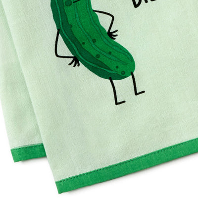 White tea towel with green border, featuring a dill pickle in sunglasses and the phrase: “Kind of a big dill.”