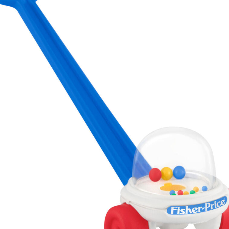 Mini Corn Popper ornament with red wheels, blue handle, and clear dome filled with colorful popping balls.

