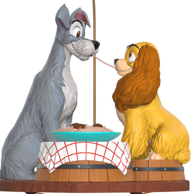 Lady and the Tramp 70th anniversary ornament featuring the Cocker Spaniel and stray dog sharing a spaghetti supper.

