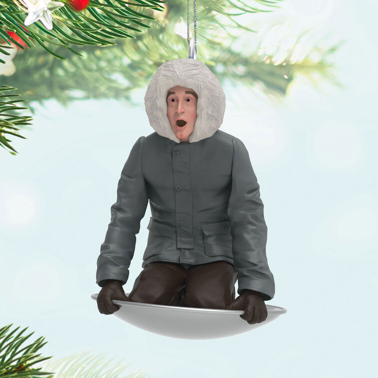 Hallmark Keepsake Mini National Lampoon’s Christmas Vacation Sledding Clark ornament—Clark in parka on saucer sled, startled expression, snowy hill