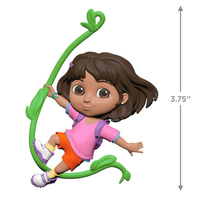 Dora the Explorer ornament swinging on jungle vine, pink shirt, orange shorts, purple backpack, Hallmark Keepsake holiday decor.