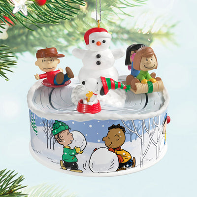 Peanuts Gang sledding ornament with Snoopy, Lucy, and snowman, light-up musical Christmas scene, Hallmark Keepsake motion collectible
