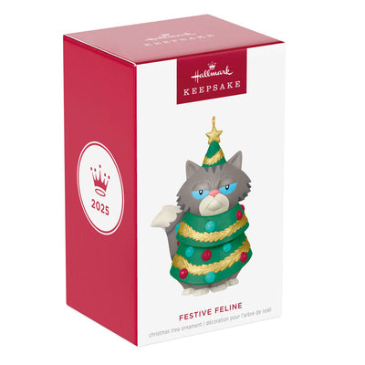 Gray-and-white tabby cat Christmas tree ornament with grumpy face, wearing festive garland and gold star

