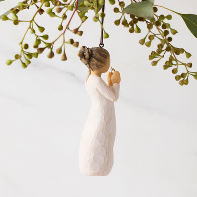 Willow Tree 2025 Ornament figurine in cream dress holding a golden wire heart with 2025 inside, hanging by a brown cord.