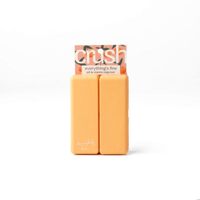 Compact pill and vitamin organizer with seven snap-close compartments and secure magnetic closure, perfect for travel and everyday use.