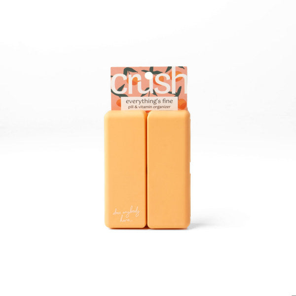 Compact pill and vitamin organizer with seven snap-close compartments and secure magnetic closure, perfect for travel and everyday use.