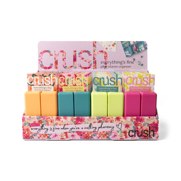 Compact pill and vitamin organizer with seven snap-close compartments and secure magnetic closure, perfect for travel and everyday use.