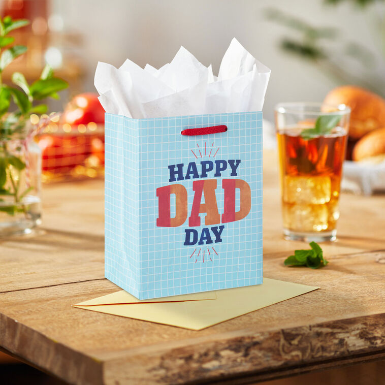 Light blue small gift bag with white grid pattern and bold &