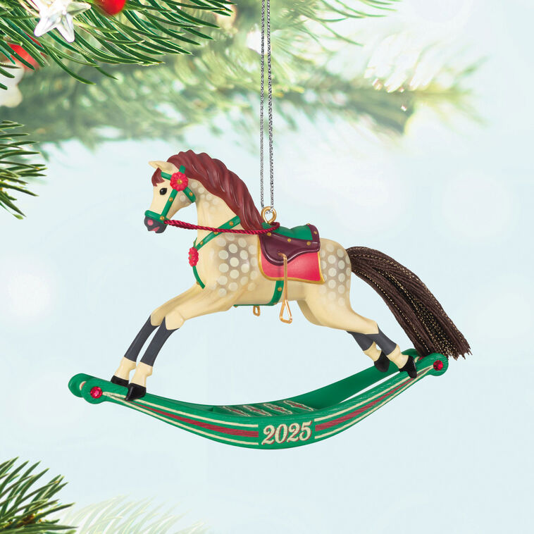 Hallmark Keepsake Rocking Horse Memories 2025 ornament—cream horse, brown mane and tail, red saddle, green sled base, red flower accents, year dated

