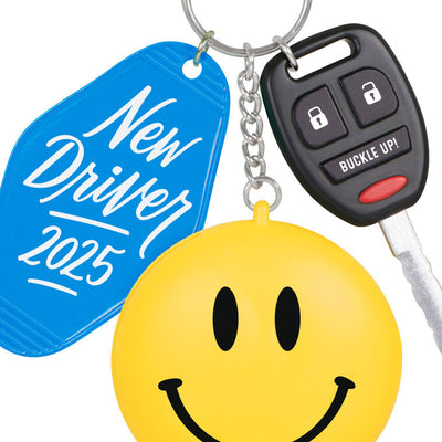 Keychain ornament with car key, smiley face, and blue “New Driver 2025” tag, featuring a small photo frame on back.