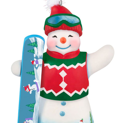 Hallmark Keepsake Ollie U. Halfpipe porcelain snowman ornament in red sweater vest, goggles, stocking hat, holding snowboard, snowy mountain scene