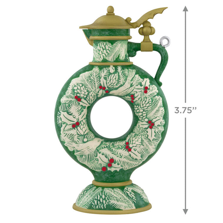 Green beer stein ornament with vintage wreath design, holly, and pinecones; features a gold lid and elegant holiday detailing.