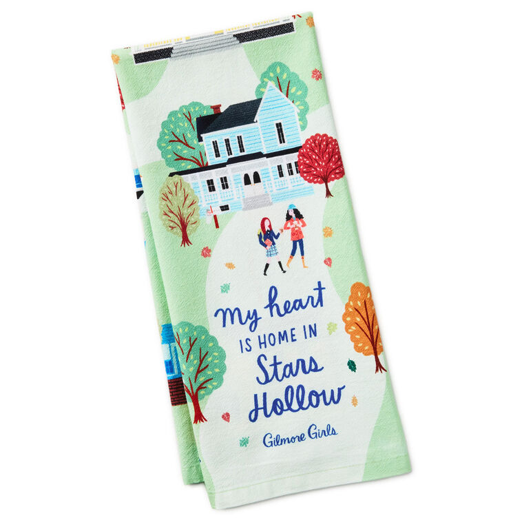 White tea towel printed with a whimsical Stars Hollow map and a central Gilmore Girls quote, includes a loop for hanging.

