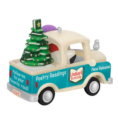 Hallmark Keepsake Holiday Parade 2025 ornament—snowman with “Word Nerd” hat drives bookshop pickup truck hauling Christmas tree made of books
