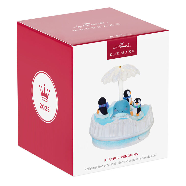 Christmas ornament with three playful penguins spinning on ice pieces around whale, lights and music, battery operated


