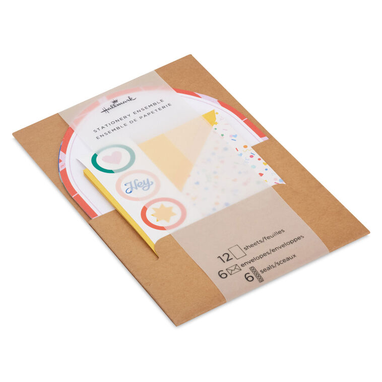 Stationery set with arched sheets in colorful wave and coral prints, yellow envelopes, and heart and star seal stickers.
