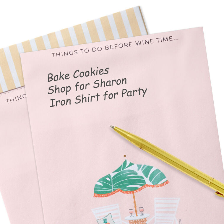 Pink to-do note pad with wine glasses, beach chairs, umbrella, and tropical leaf accents on a striped header.
