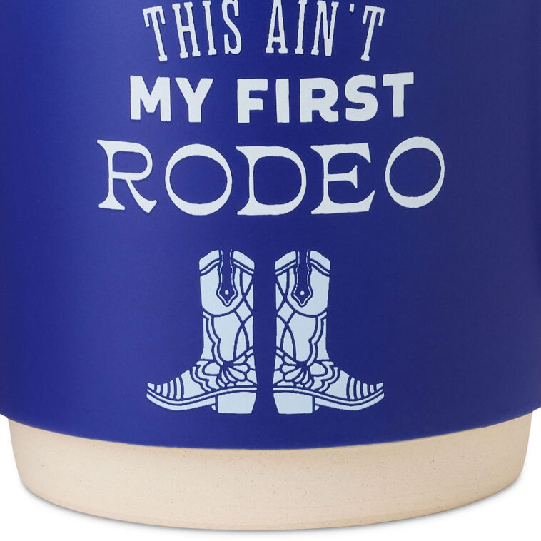 Cobalt blue ceramic mug with white text that reads “This ain&