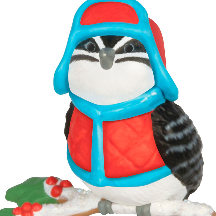 Miniature downy woodpecker ornament in red vest and trapper hat on snowy branch with holly berries, Hallmark Cozy Lil’ Critters
