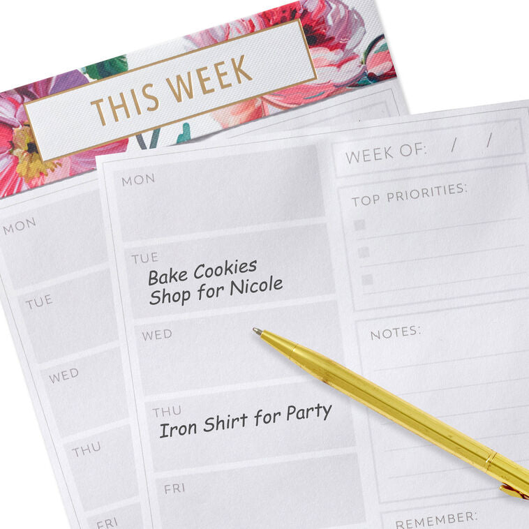 Floral weekly planner pad with gold foil accents and tear-off sheets for notes and scheduling.