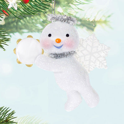 Glittery snow angel snowman ornament with tinsel halo, snowflake wings, rosy cheeks, and holding a tambourine


