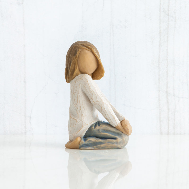 Willow Tree Joyful Child figurine of kneeling girl with arms folded on knees.
