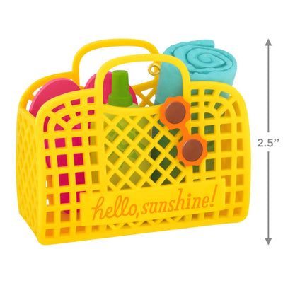 Yellow beach bag ornament with flip-flops, swim towel, sunglasses, and sunscreen, perfect for summer-themed holiday decor


