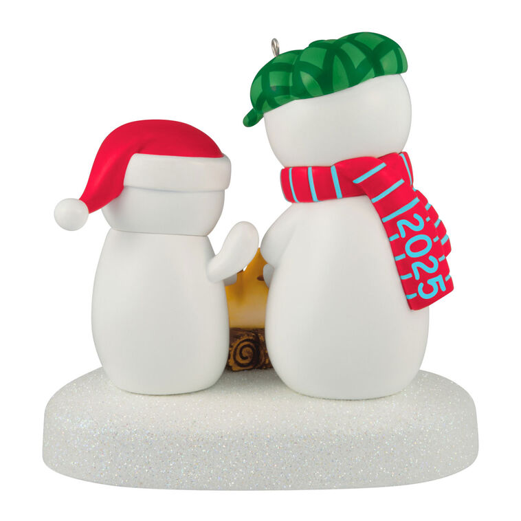 Two snowmen in red and green hats roasting marshmallows over a fire, sparkly base, musical Christmas ornament, battery opera
