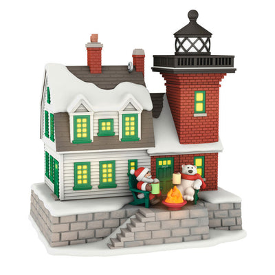 Hallmark Keepsake ornament of a brick lighthouse and home with Santa and polar bear, glowing windows and beacon, Holiday Lighthouse 2025