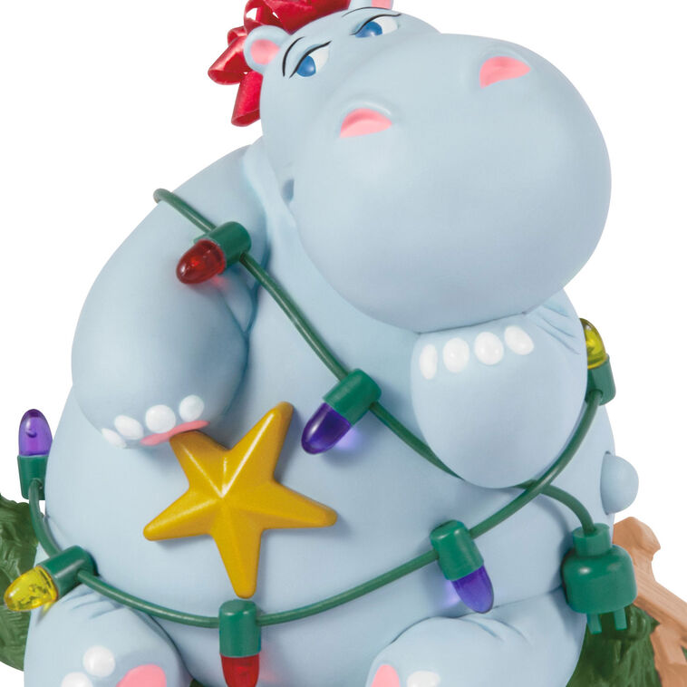 Hippopotamus Christmas ornament tangled in lights on a squished tree, plays holiday song, battery operated

