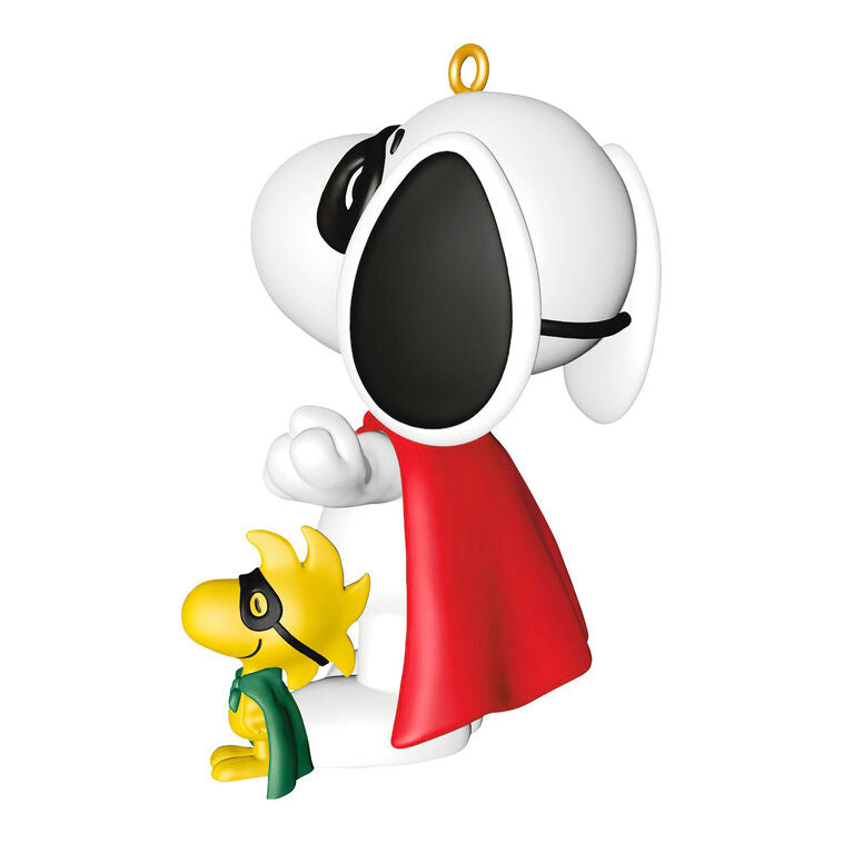 Hallmark Keepsake Peanuts ornament of Snoopy and Woodstock wearing superhero capes and masks, posed as festive holiday heroes.