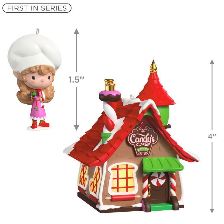 Two-piece ornament set with a festive bakery shaped like a gingerbread house and a smiling elf named Candy holding chocolate cake.