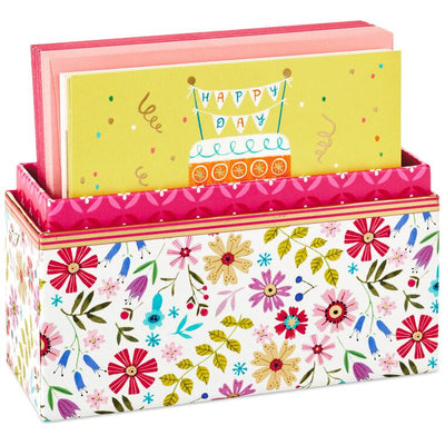 Assorted whimsical note cards with gold foil accents in multiple designs, includes envelopes and reusable caddy.