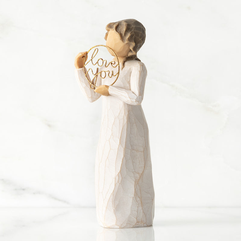 Willow Tree Love You figurine holding gold wire circle with message.