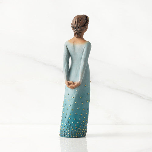 Willow Tree Radiance figurine with darker skin in a deep blue ombré dress dotted with gold leaf.