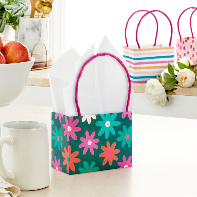 Assorted mini horizontal gift bags with pink stripes, polka dots, squiggles, and multicolor daisies, pink handles, Hallmark

